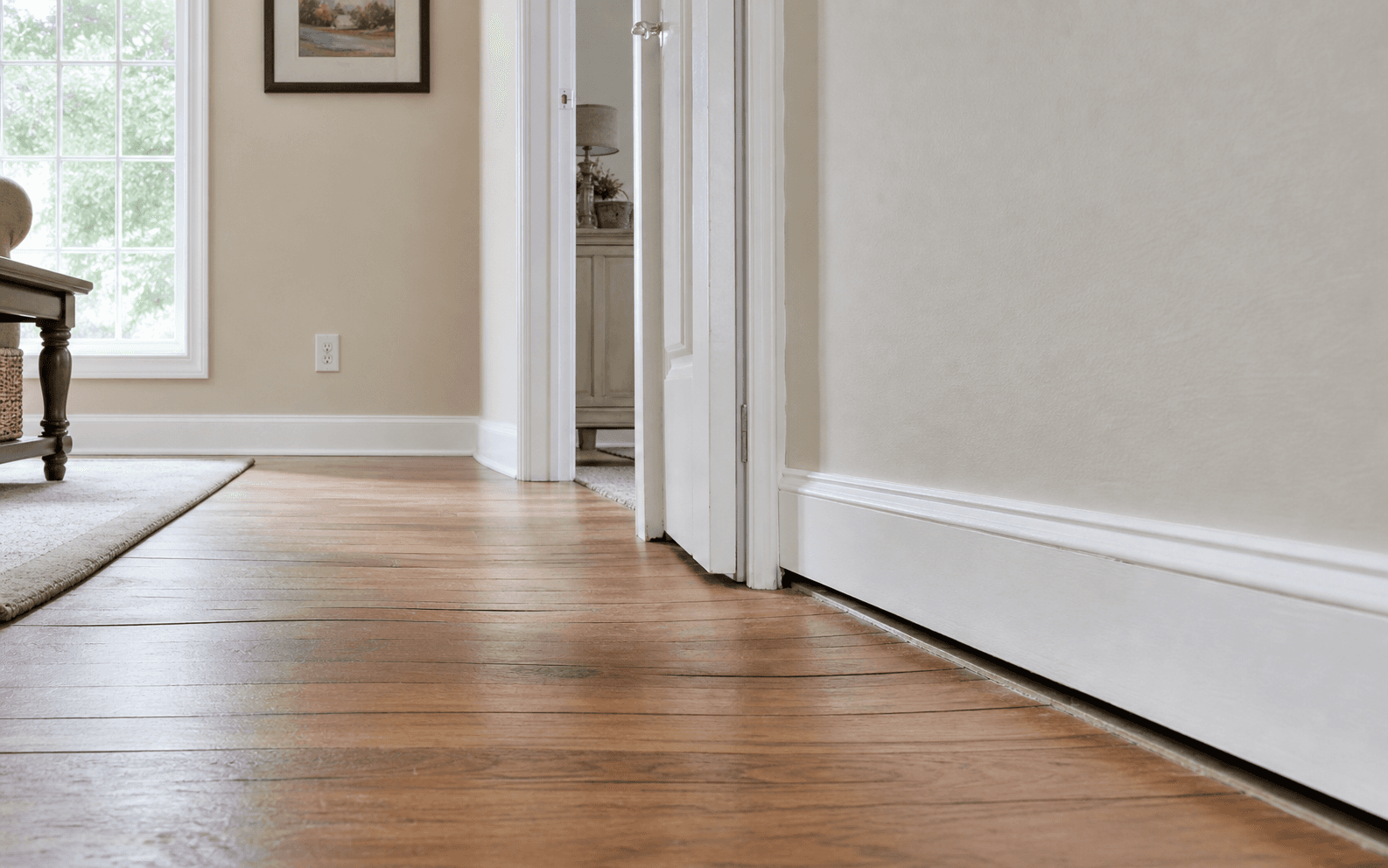 Subtle sagging floor signs with a baseboard gap and doorway alignment issue