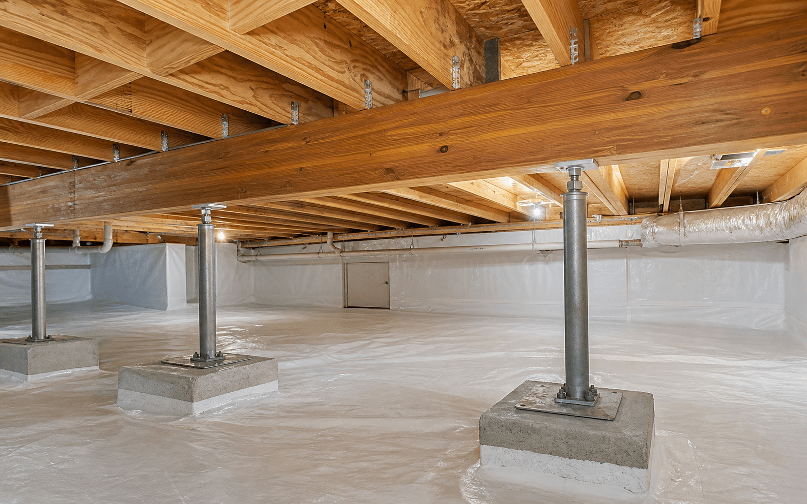 Repaired crawl space beam and girder supported by steel posts on concrete footings