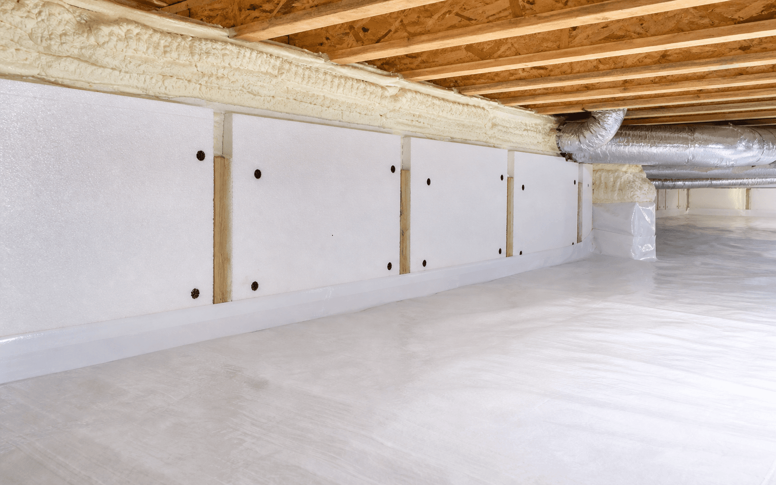 Clean sealed crawl space with wall insulation panels and rim joist insulation